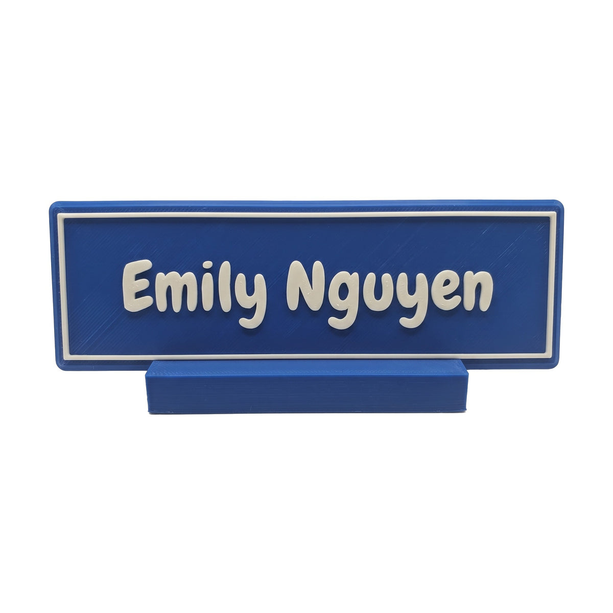 Example personalisation: Small blue desk name plate and foot with white raised lettering and border reading Emily Nguyen