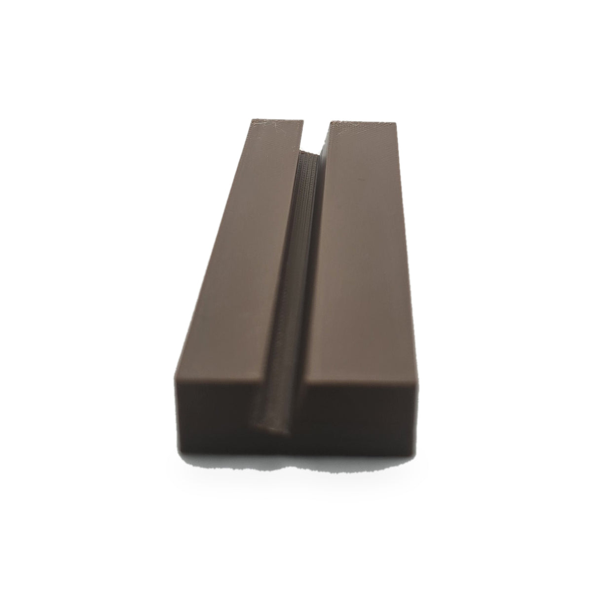The brown slotted foot on its own, showing the angled slot the plate stands in