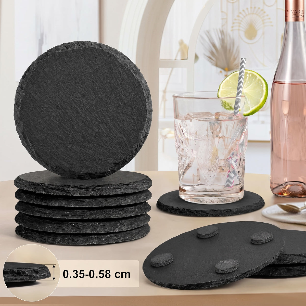 Round natural slate stone coasters stacked, with rubber feet, a glass of iced water and a 0.35 to 0.58 cm thickness label