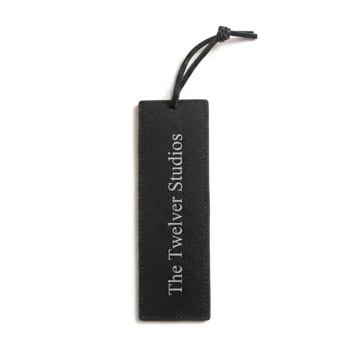 Black PU leather bookmark with cord tie, engraved in silver with The Twelver Studios, on white